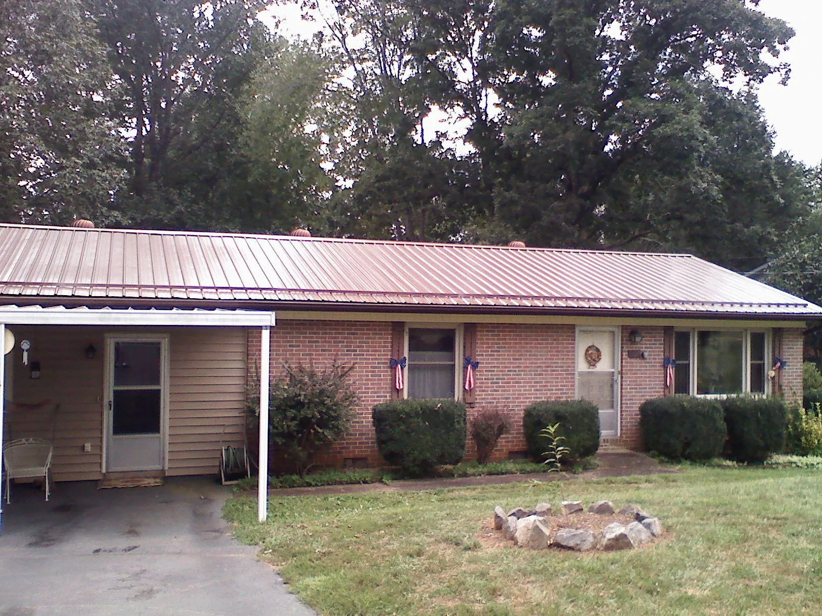 Bronze metal roof and carport on a brick ranch home — Roof Repair work by our crew in Princeton Junction