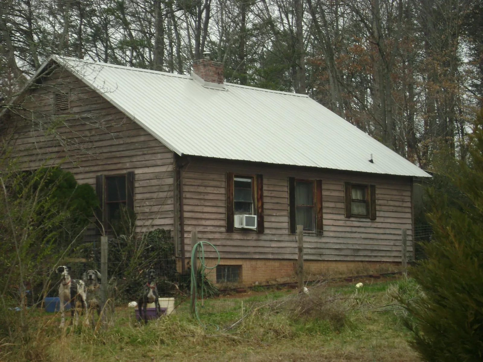 White metal roof on an old wood sided farmhouse, from a Metal Roof Installation job in Princeton Junction